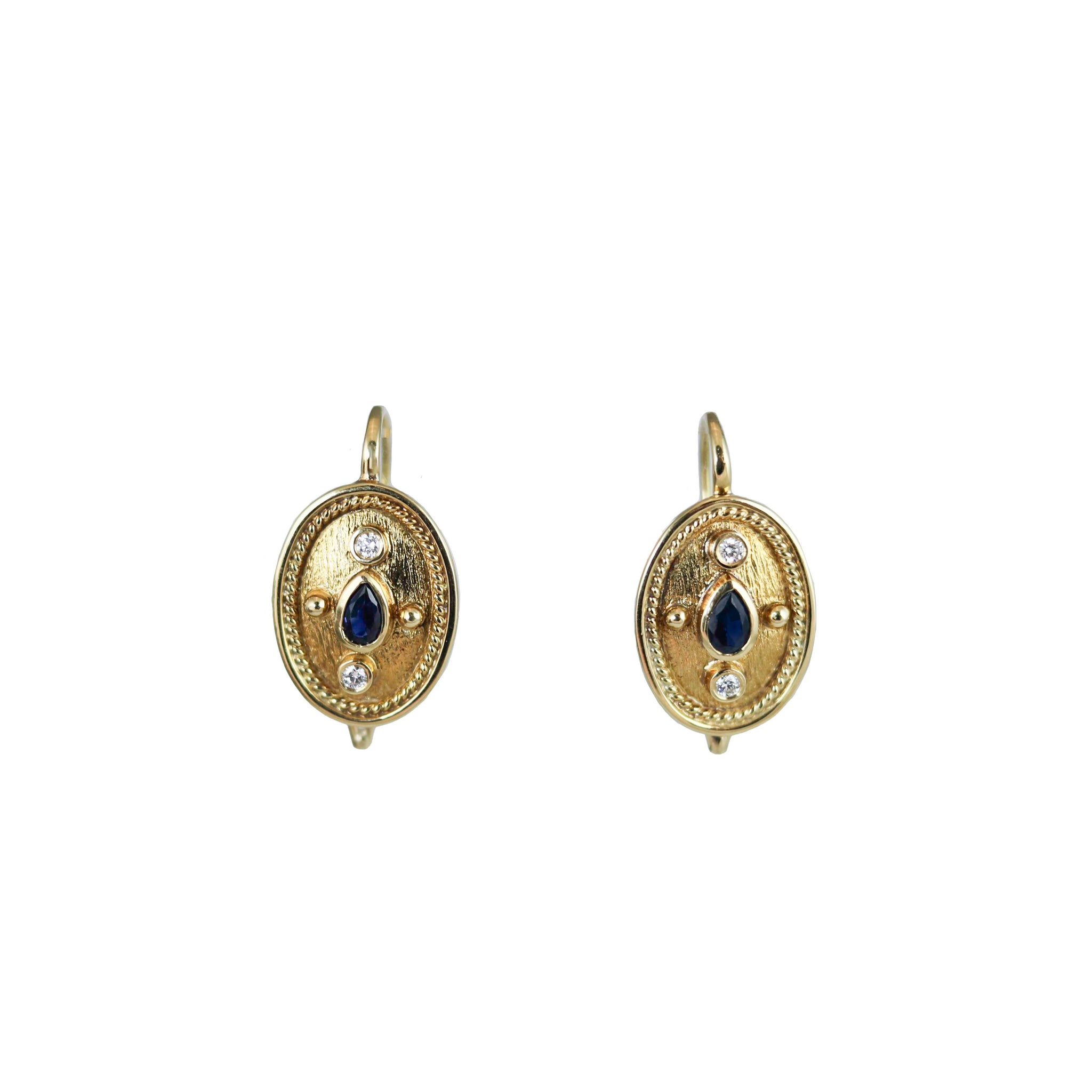 These 18ct yellow gold, Etruscan revival style earrings are set with diamonds and a centre sapphire |