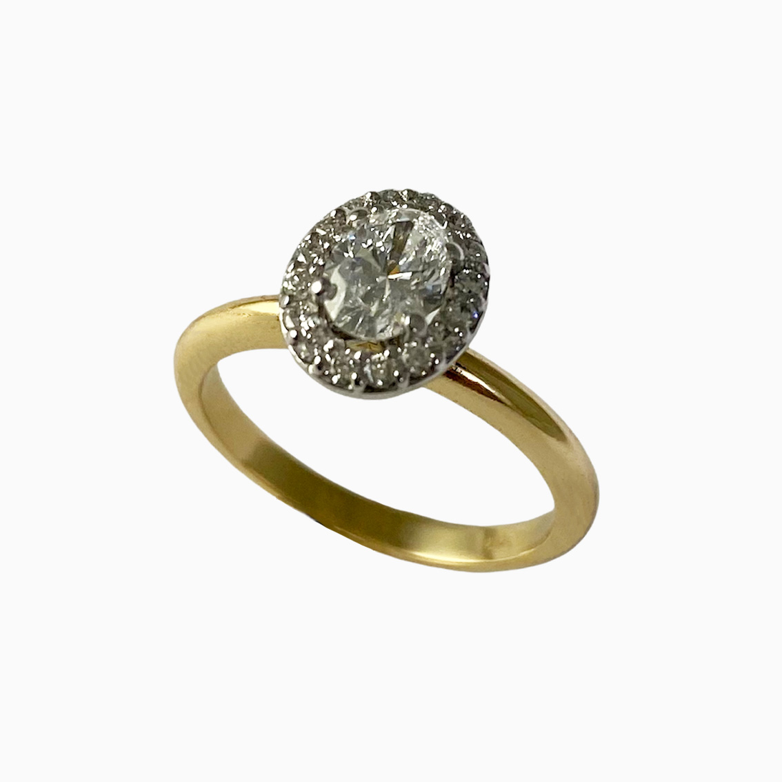 Contemporary 18ct. Yellow and white gold diamond set halo ring